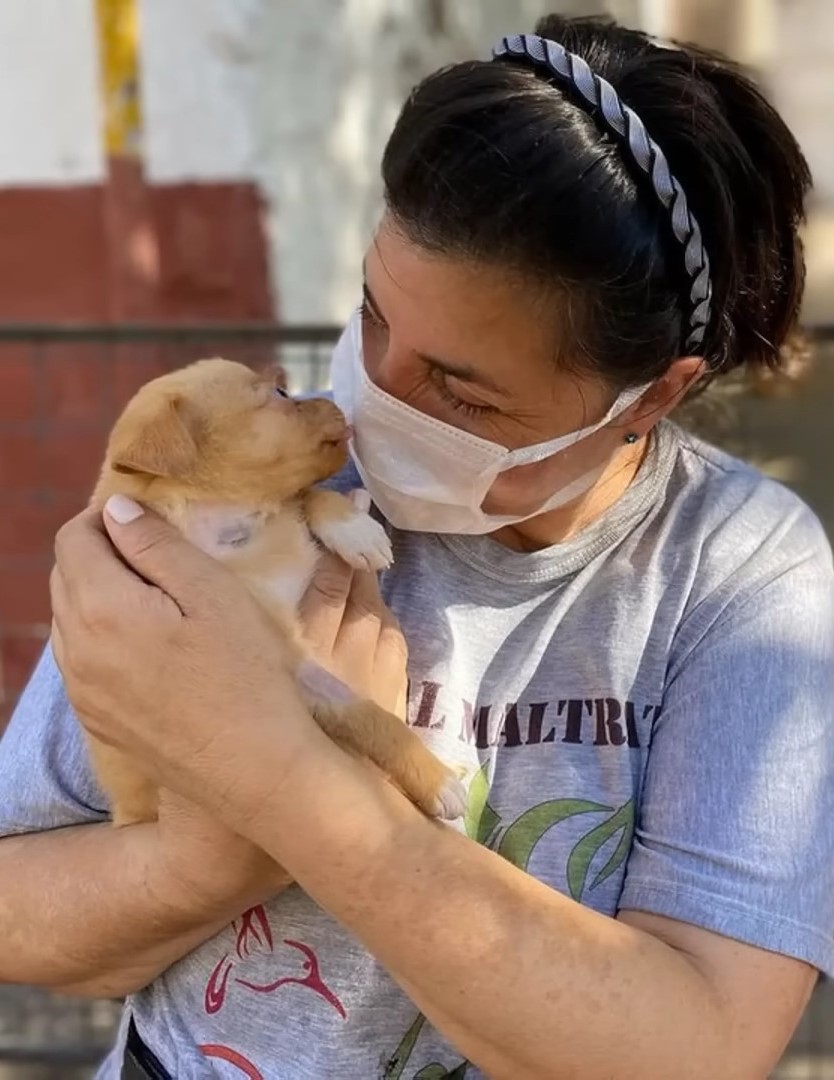 woman holding a puppy