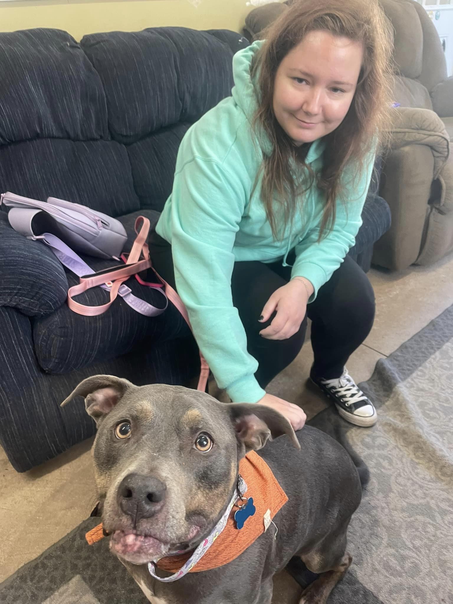 woman in a hoodie and dog